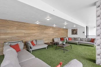 Indoor lounge with couches and chairs at Bay Village 1 Apartment in Palmetto Bay, FL